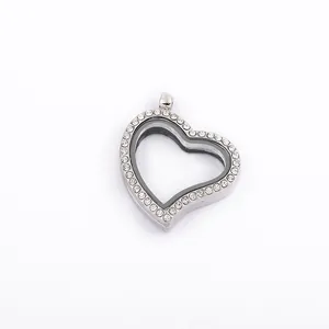 Close-up of a silver heart-shaped floating locket pendant with pavé set rhinestones.