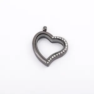 Macro detail of heart-shaped black metal floating locket with rhinestones and glass