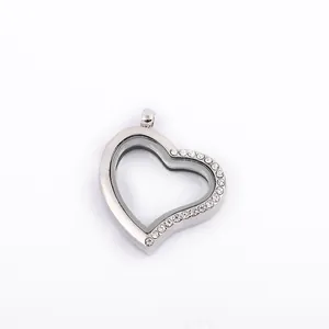 Close-up view of a heart-shaped silver floating locket pendant with sparkly rhinestones