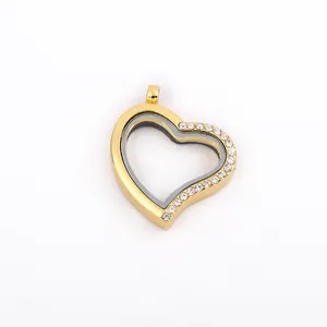 Detail of a gold heart-shaped floating locket with sparkling rhinestone accents.