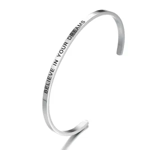 Minimalist stainless steel open bangle engraved with 'Believe in Your Dreams' phrase