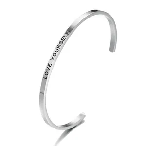 Detail shot of silver stainless steel cuff bracelet engraved with LOVE YOURSELF