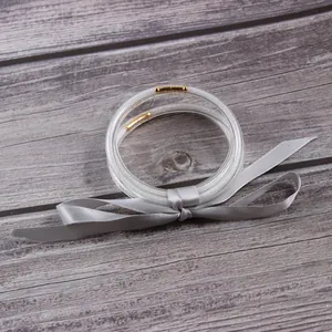 Detailed view of five-layer glitter silicone jelly bangles tied with a stylish grey ribbon