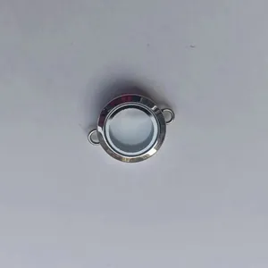 Close-up of a circular transparent stainless steel Gawu box pendant