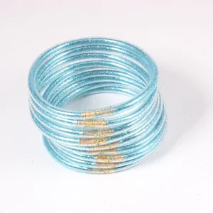 Macro detail of blue glitter filled PVC jelly bangles in a set of 12 pieces.