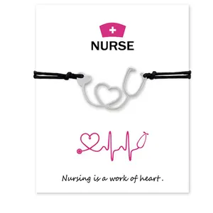 Detailed view of stethoscope heart charm bracelet on nurse theme gift card.
