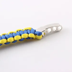 Close-up detail of blue and yellow paracord weave and sturdy metal clasp for survival bracelet