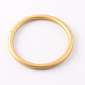 Close-up detail of a minimalist matte gold silicone bracelet for women's summer fashion wear