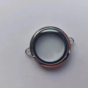 Close-up view of a circular transparent silver glass locket pendant for jewelry making