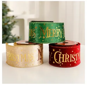 Close-up of green, gold, and red velvet ribbons with gold foil Merry Christmas print