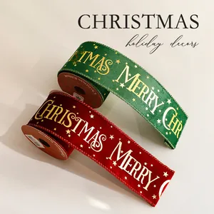 Gold foil Merry Christmas ribbon rolls in red and green for gift wrapping and holiday decor