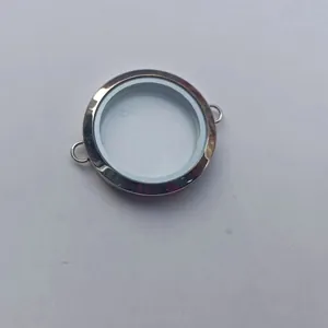 Macro view of a circular transparent locket frame with dual side attachment loops