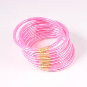 Macro view of pink glitter jelly bangles with gold connectors in a set of 12 pieces