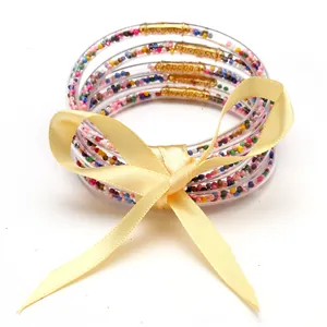 5-layer silicone jelly bangles set with colorful interior beads and a yellow bow