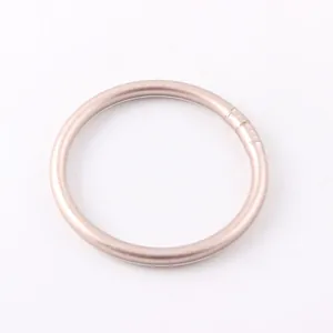 Close-up of a minimalist matte silicone ring bracelet in elegant rose gold finish
