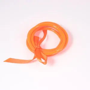 Set of bright orange translucent silicone jelly bangles with decorative ribbon bow tie