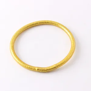 Close-up of flexible gold glitter silicone bracelet for women's summer fashion