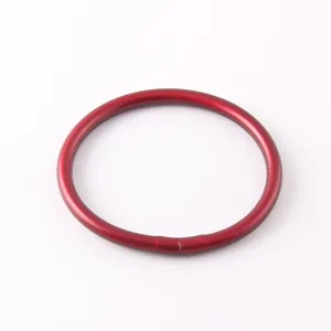 Top view of a minimalist matte red silicone bangle bracelet on a white background