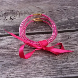 5-piece set of pink silicone seed bead bangles with decorative silk ribbon bow