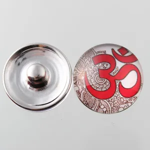 Detail of 18mm Noosa snap button featuring red Om symbol and mandala pattern