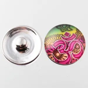Detailed macro view of an 18mm Noosa snap button featuring a colorful Om mandala