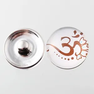 Detail shot of 18mm Noosa snap button with brown Om symbol for DIY jewelry making