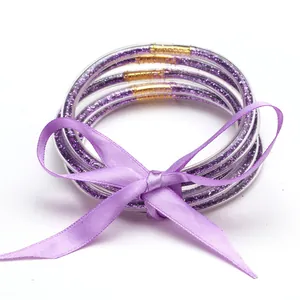 Elegant set of 5 purple glitter silicone jelly bangles tied with matching ribbon bow