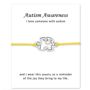 Bracelet de sensibilisation à l'autisme avec breloque puzzle argentée sur carte
