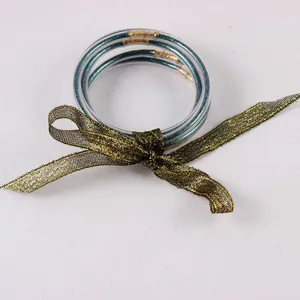 Set van 5 siliconen jelly armbanden met glitter en decoratief gouden lint