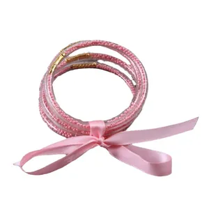 Set of 5 pink silicone bead bangles with decorative ribbon bow