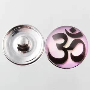 Detailed view of 18mm Noosa snap button featuring Om symbol under purple glass dome