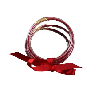 Five-layer red silicone jelly bangles with internal beads and decorative ribbon bow