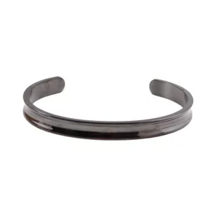 Side view detail showing the sleek 7mm black stainless steel C-shaped cuff bracelet