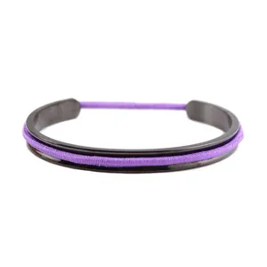 Close-up of a black stainless steel C-shaped cuff bracelet with a purple elastic hair tie