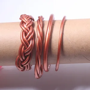 Detailed view of 4 copper-toned jelly bangles featuring braided and smooth designs.