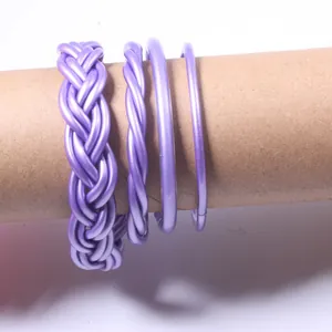 Detail showing 4-piece set of purple jelly bangles with braided and smooth designs.
