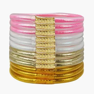 Sparkling set of 12 glitter-filled PVC jelly bangles with decorative gold metal sleeves