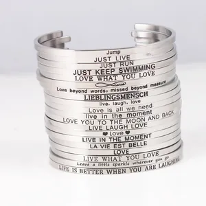 Stack of stainless steel mantra bracelets with inspirational engraved quotes and sayings