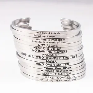Detailed stack of stainless steel mantra bracelets with engraved inspirational quotes