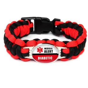 Detail view of the red and black braided paracord bracelet with a medical alert diabetic tag