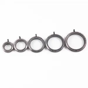 Detail view of black stainless steel round locket pendants with rhinestone trim