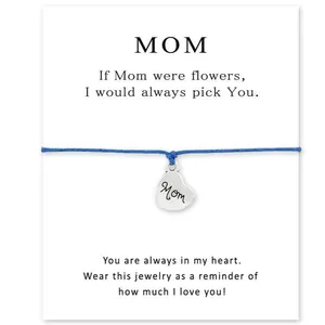 Blue woven string bracelet with engraved heart charm on Mother's Day sentiment gift card