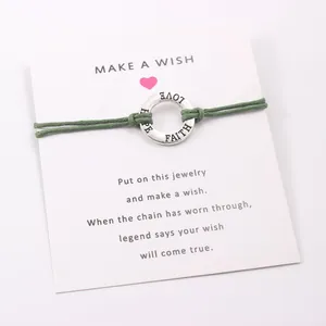 Minimalist green wax cord bracelet with engraved FAITH HOPE LOVE alloy ring on wish card