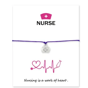 Purple waxed cord bracelet with nurse cap charm on inspirational card for medical staff.