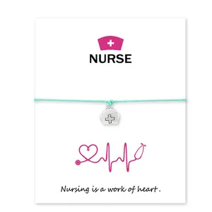 Detail of nurse charm bracelet on gift card with Nursing is a work of heart quote