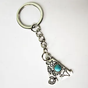 Detailed view of vintage silver stainless steel letter A keychain with turquoise inlay