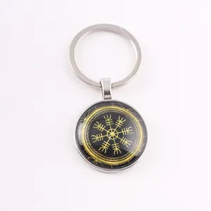 Detailed macro view of a Norse Viking Vegvisir runic compass keychain with glass cabochon finish