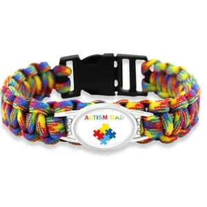 Detailed macro view of Autism Dad rainbow paracord bracelet with puzzle heart logo