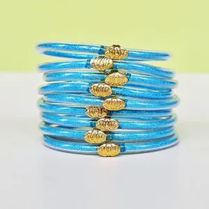 Lot de 9 bracelets en silicone pailleté bleu avec boucles lotus dorées pour femmes.