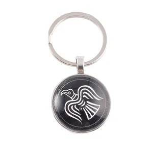 Norse Viking raven pendant keychain with glass cabochon on a white background image